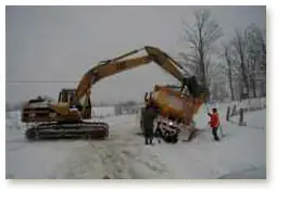 Snowplow in ditch in front of Mesa Springs